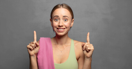 feeling awed and open mouthed pointing upwards with a shocked and surprised look