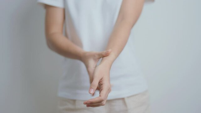 Woman having wrist pain at home, muscle ache due to De Quervain s tenosynovitis, ergonomic, Carpal Tunnel Syndrome or Office syndrome and Parkinson disease concept