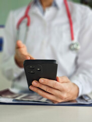 Doctor pressing his finger on screen of mobile phone closeup. Doctor call concept vertical