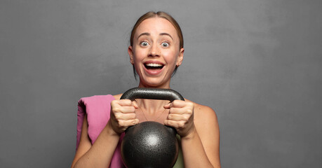 blonde fitness woman lifting a dumbbell