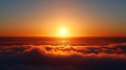 Obraz premium A vibrant sunset over a sea of clouds, with the sun casting a warm glow on the horizon.