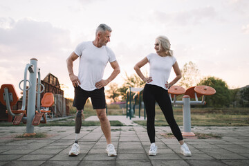 Active amputee exercising with his female friend