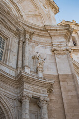 Detail of exterior ornament of the Cathedral of La Santa Cruz with columns and archangel holding cross, Cádiz SPAIN
