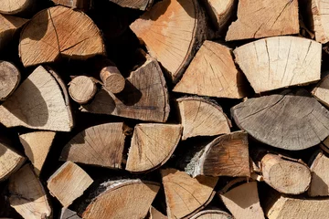 Foto op Plexiglas Firewood (wooden background) close-up stacked in a woodpile © TETYANA