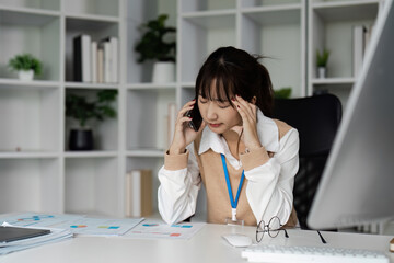 Stressed Office Worker Experiencing Office Syndrome at Desk with Computer and Documents in Modern Workplace