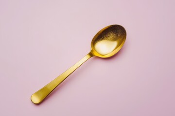Collagen powder in a gold spoon on a soft pink gray backdrop