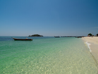 Serene Tropical Beach with Turquoise Waters and Longtail Boat in Thailand, Koh Lipe
