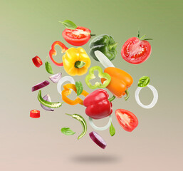 Many different fresh vegetables in air on green pink gradient background