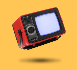 Retro TV set in air on orange background