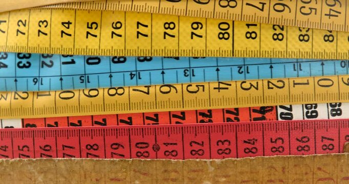 Multiple measuring tape of the tailor in motion