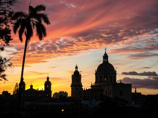 Fototapeta premium Captivating Silhouette Photography of Santo Domingo's Skyline Against a Vibrant Sunset, Showcasing Iconic Landmarks and the Beauty of the Republic Dominican Capital