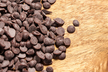 Chocolate ingredient in drop-shaped chips. Sweet cocoa morsels for melting and adding to desserts