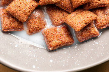 Chocolate cereal corn squares in rice milk, highlighting a mix of soft and crunchy textures, ideal for a delicious breakfast. Top view