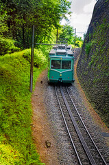 Fototapeta premium Electric railcar of the Drachenfels Railway (Drachenfelsbahn) on its way to the summit of the Drachenfels mountain, Königswinter, North Rhine-Westphalia, Germany