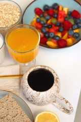 Assortment of various breakfast foods and drinks on the white table. Selective focus.