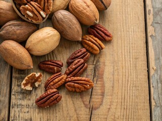 Close-Up Pecan Shells and Nuts on Rustic Wood Background with Copy Space for Text or Design, Ideal for Food Photography, Healthy Snack Concepts, or Culinary Use