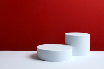 White podiums on color background 
