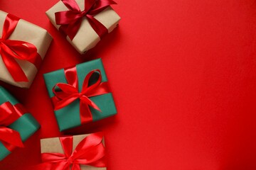 Beautiful gift boxes tied with golden bows on color background 