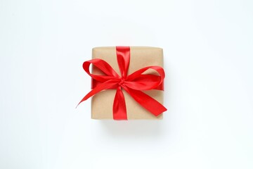 Beautiful gift box tied with golden bow on color background 