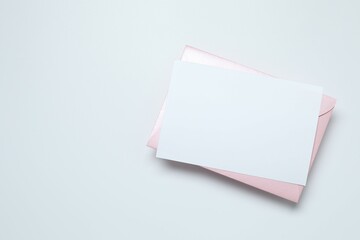 Pink envelope with paper card on white background