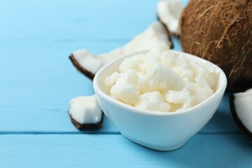 Bowl of coconut oil on wooden background