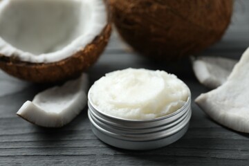 Jar of coconut oil on wooden background