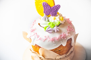 Board with delicious Easter cake and eggs on white background . Close-up of easter eggs with flowers and cake over white background