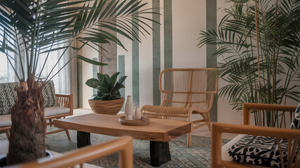 Stylish living room featuring natural decor, a wooden coffee table, rattan chairs, and vibrant indoor plants for a cozy atmosphere.