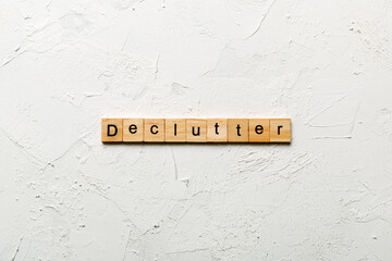 Declutter word written on wood block. Declutter text on cement table for your desing, concept