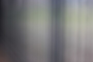 A blurry dreamy view of a metal gate.