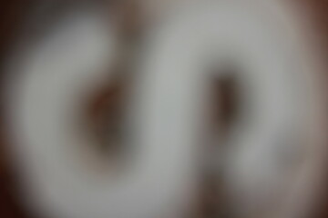 A blurry dreamy view of a bright  letter s in black and white.