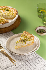 Homemade Vegetable leek Quiche Served Beautifully on a Stylish, Elegant Plate on tableware. Vegeterian dish concept