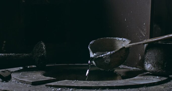 Super slow motion close-up of aluminum melting in foundry at 1000 fps. Raw metal is heated in furnace until molten, then kept at  stable temperature for pouring