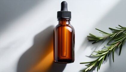 Fototapeta premium amber glass roll on bottle mockup with a rosemary on the white table