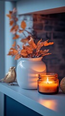 Cozy autumn decor with a candle and decorative leaves by a window in a warm living space