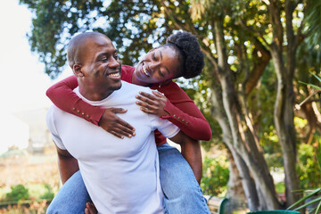 Fototapeta premium Joyful Couple Sharing a Playful Moment in the Park During a Sunny Day, Embracing Happiness and Love
