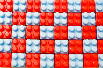Red and blue toy blocks arranged crosswise. Educational toys for children