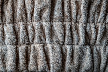 Wrinkled beige fur wool abstract pattern nature skin soft warm fluffy for background and texture, closeup, top view