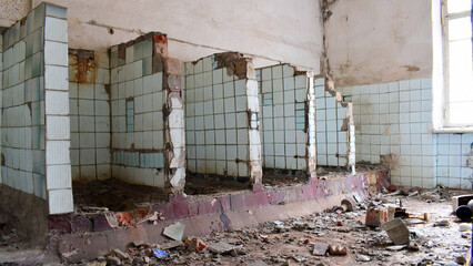 a ruined room, a public toilet. destruction, abandoned premises. partitions between toilets. Mental Hospital Bathroom. old abandoned premises, ruin. empty territories, abandoned houses