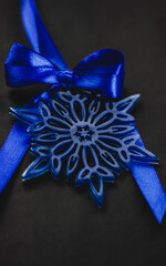 Blue snowflake Christmas tree ornament with satin bow, elegant festive decoration in wintry theme for holiday celebrations