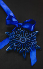 Blue snowflake Christmas tree ornament with satin bow, elegant festive decoration in wintry theme for holiday celebrations