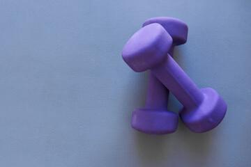 Dumbbells, weightlifting or equipment with space for workout, exercise or training in studio on a blue background. Closeup, weights or gym tools for fitness, strength or health and wellness on mockup