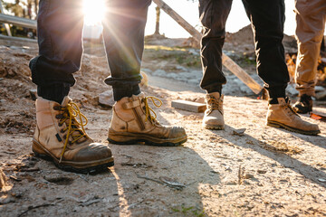 Builders wearing working boots and pants.