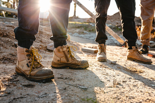 Builders wearing working boots and pants.