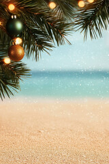 A festive scene featuring a beach with soft sand and a decorated Christmas tree branch adorned with ornaments, capturing a unique holiday vibe.