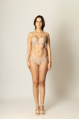 Fototapeta premium Confident Studio Portrait of a Stylish Woman Model – Professional Fashion Shoot with Natural Poses, Expressive Look, Clean Background – Diversity, Beauty, Elegance, Authentic Presence