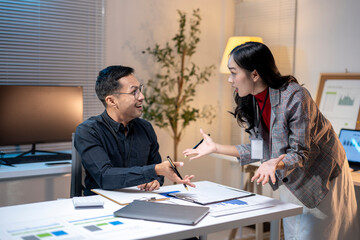 Two business people having disagreement during meeting in office at night