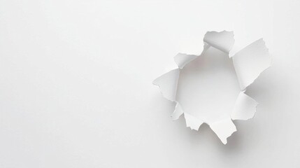 A close-up view of a torn piece of white paper against a minimalistic background, showcasing a creative design element for various projects.