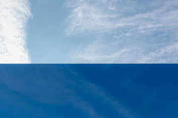 Glass window and reflection, Stratus clouds are low-level clouds characterized by horizontal layering with a uniform base, Natural gradient colour of blue sky on mirror, Abstract pattern background.