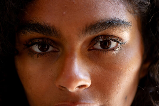 Close-up of woman's eyes showing thoughtful expression in natural light, at home